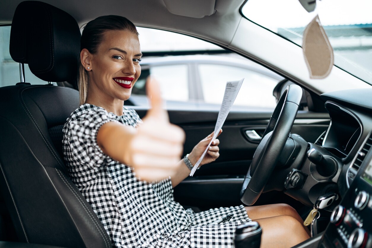 Customer sitting inside a used vehicle examining the interior