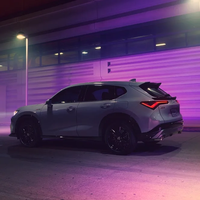White Acura ADX shown from the side at night with purple lighting