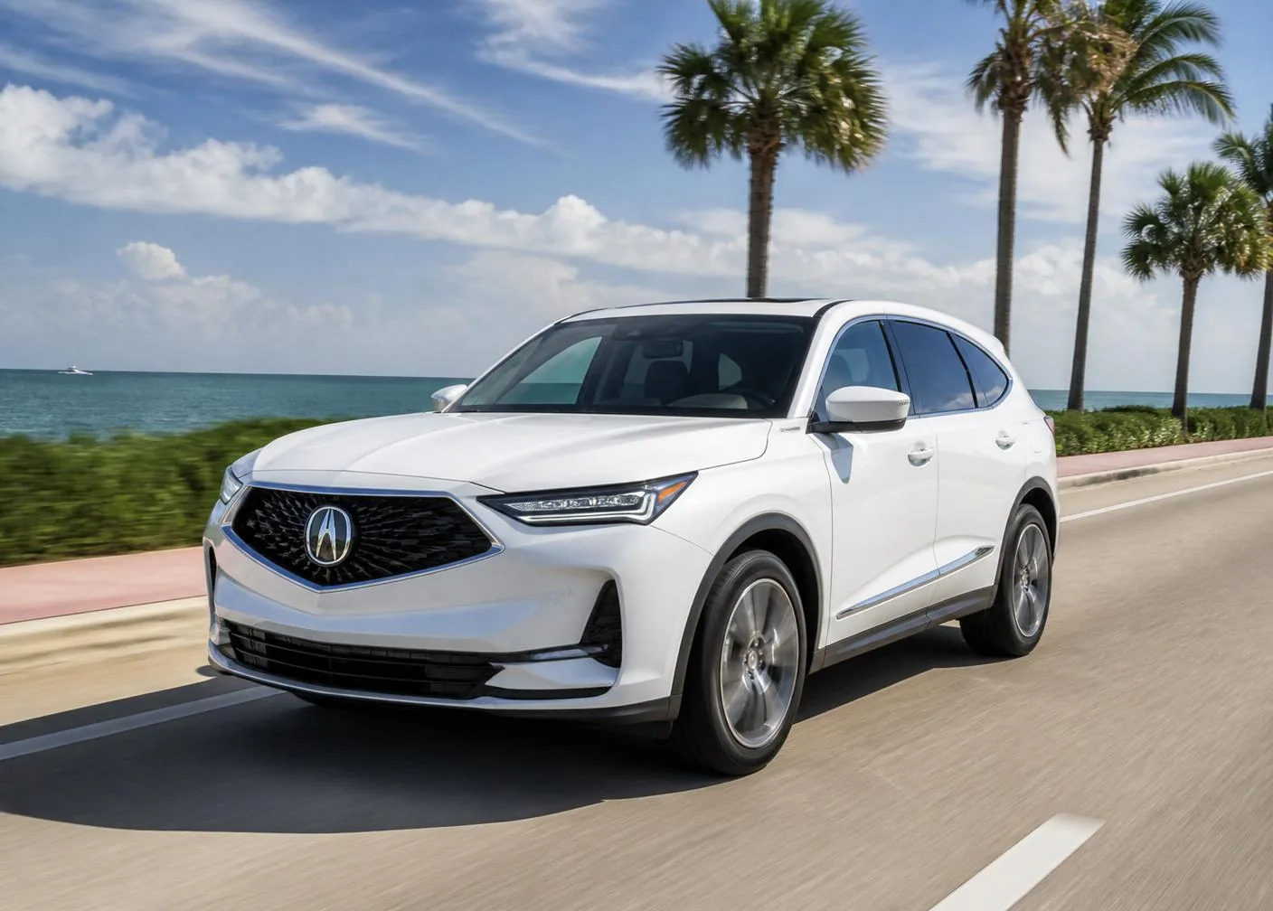 White 2026 Acura MDX driving along the South Florida coastline with palm trees and ocean