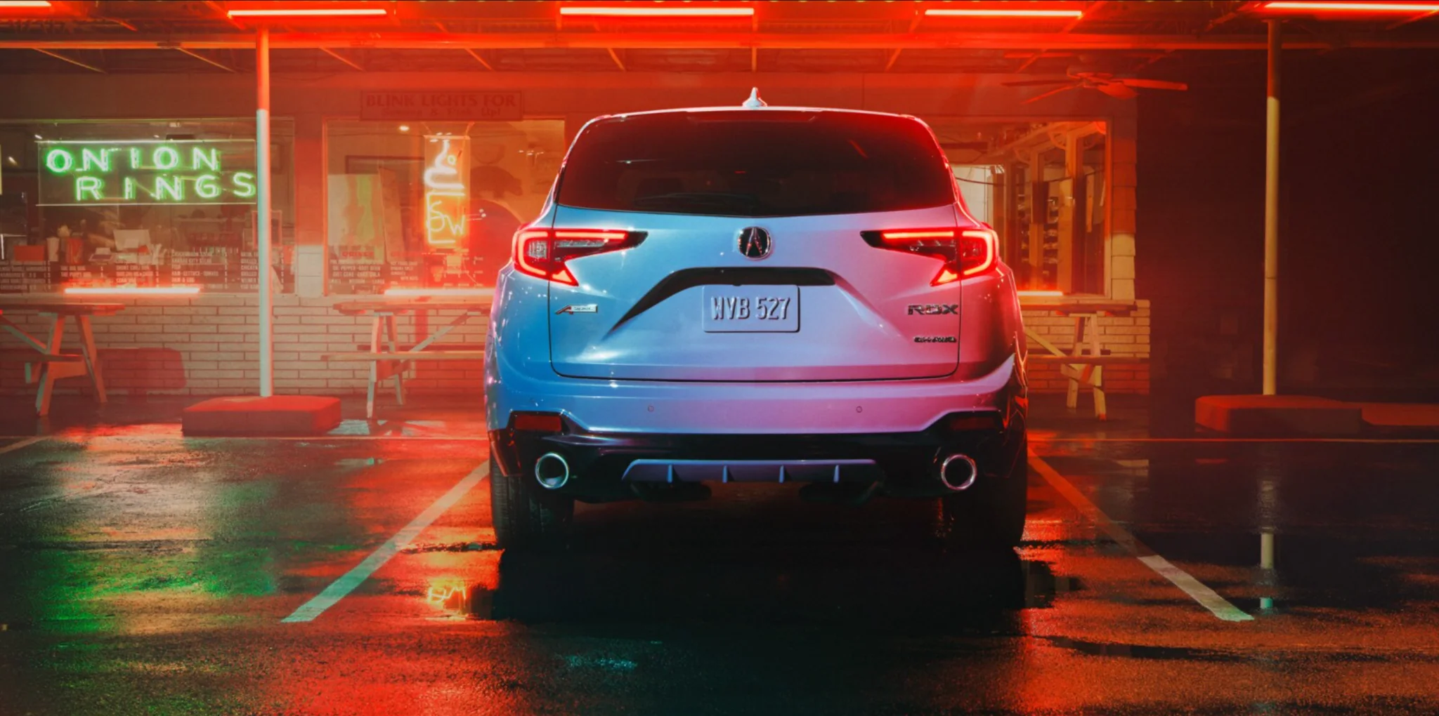 2026 Acura RDX Rear Exterior View Rear view of a 2026 Acura RDX illuminated at night