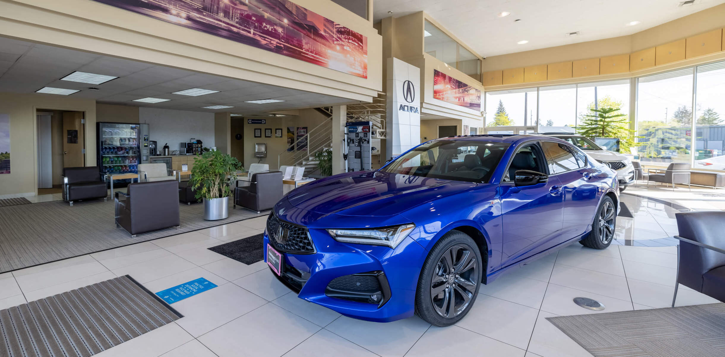 AutoNation Acura Spokane Autonation Acura interior with blue Acura car parked inside