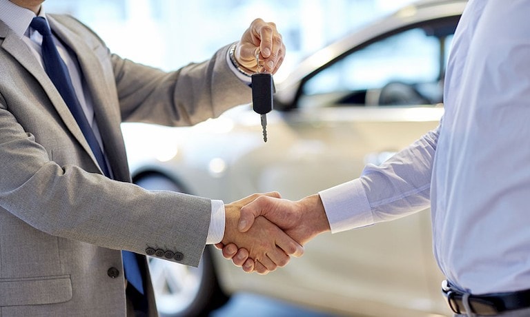 Man giving keys to customer