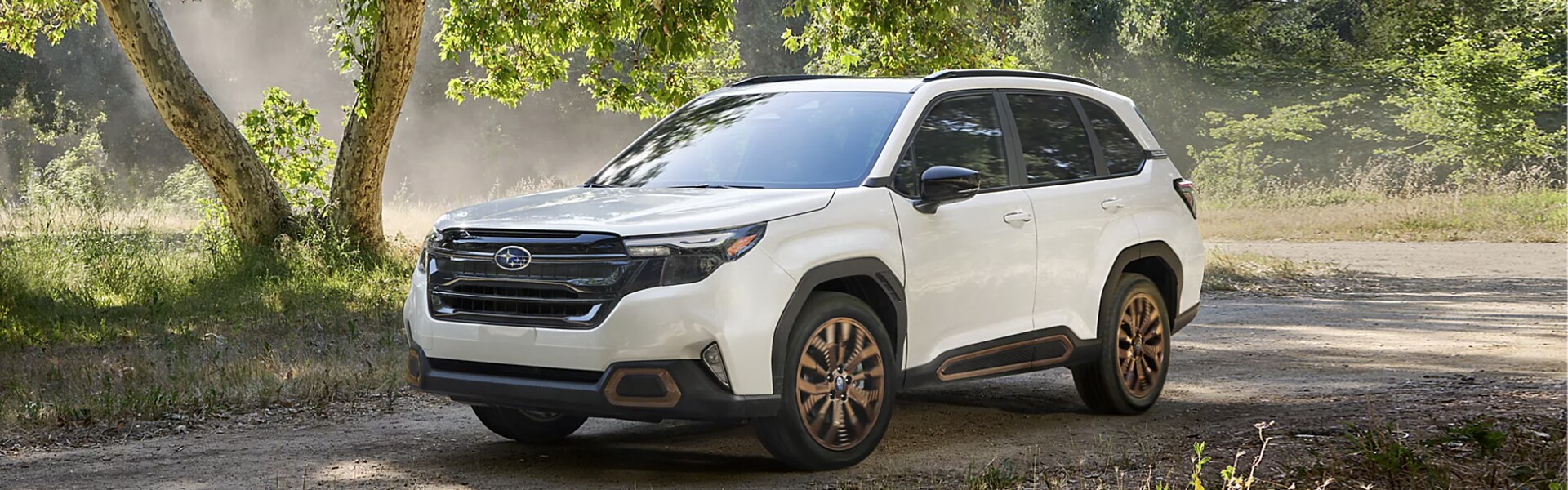 2025 Subaru Forester in white parking outdoor trees in background.png 2025 Subaru Forester in white parking outdoor trees in background