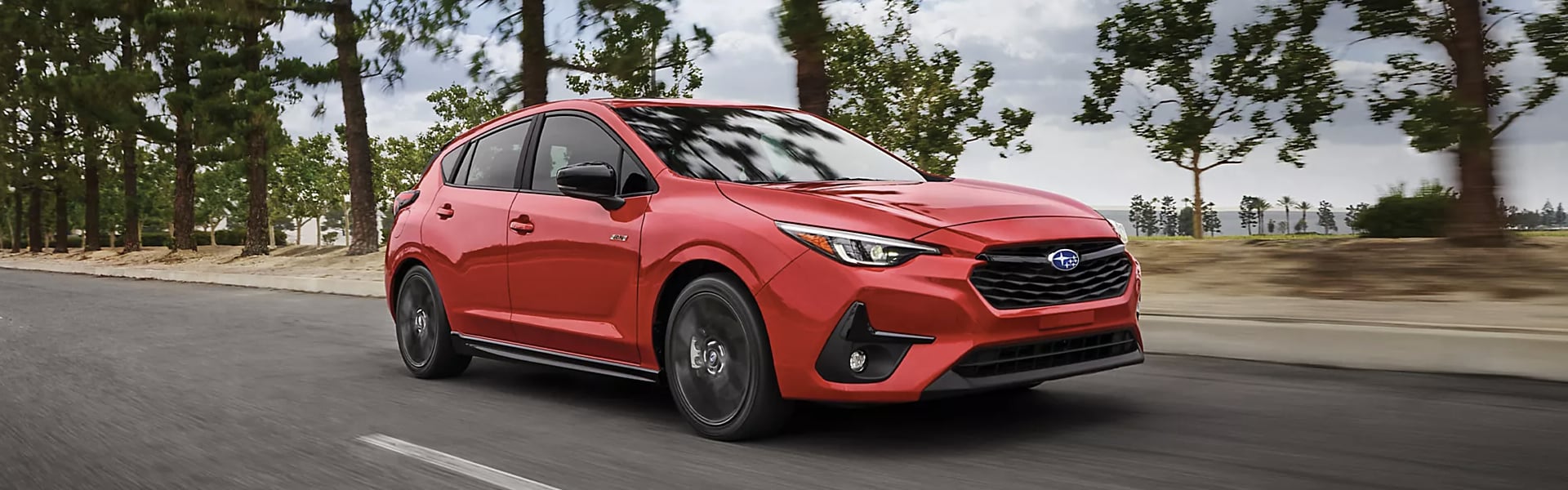 2024 Subaru Impreza in red running on street.png 2024 Subaru Impreza in red running on street