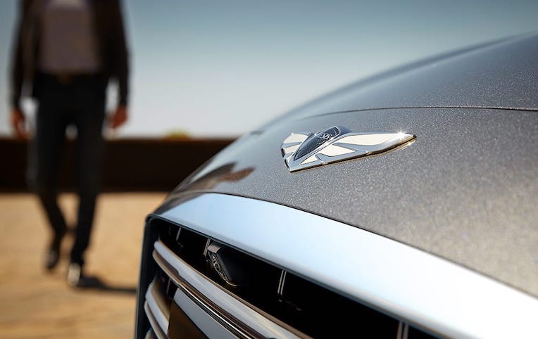 man-walking-towards-genesis-g80