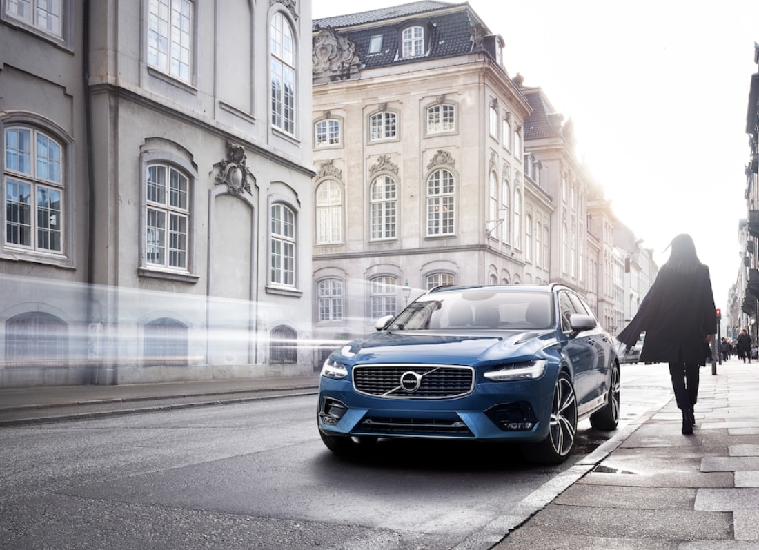 Blue Volvo V90 near building