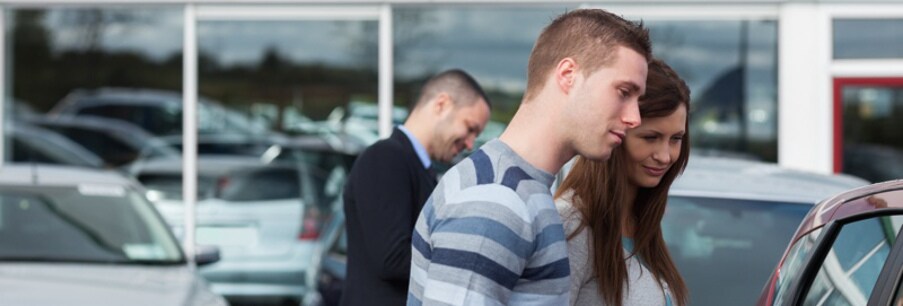Couple looking at a cars