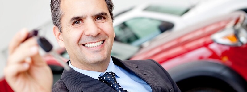dealer holds car keys