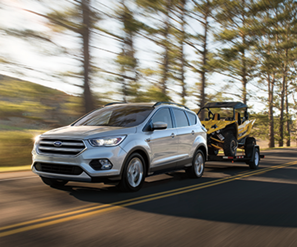 grey 2018 Ford escape pulling an ATV