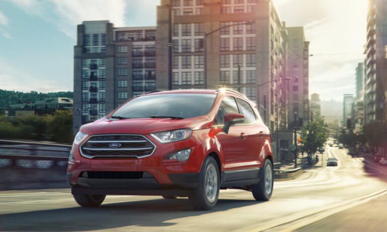 Red 2019 Ford EcoSport driving in city exterior view