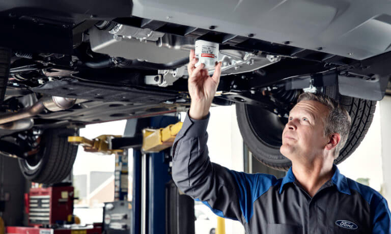 Ford Service Technician replacing oil filter