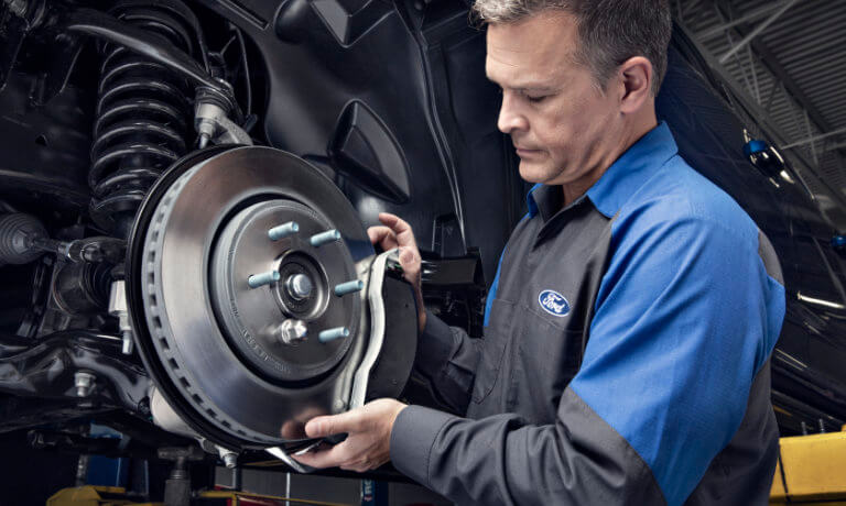 Ford Service Technician working on brake repair