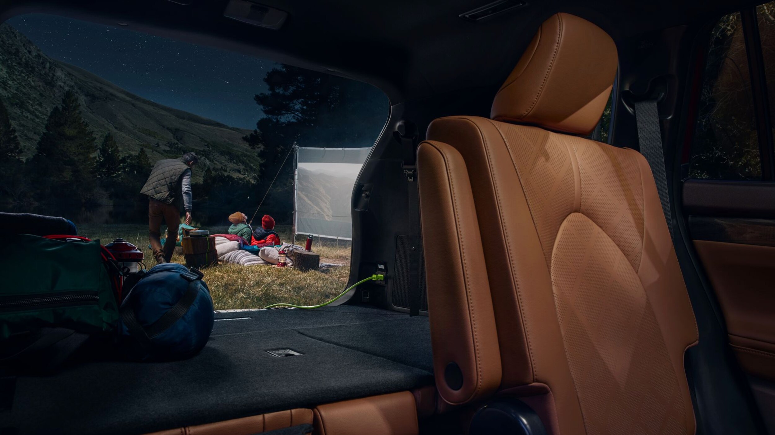 New 2024 Toyota Highlander Hybrid Platinum AWD interior shown in Glazed Caramel leather trim near Bryan, TX.png