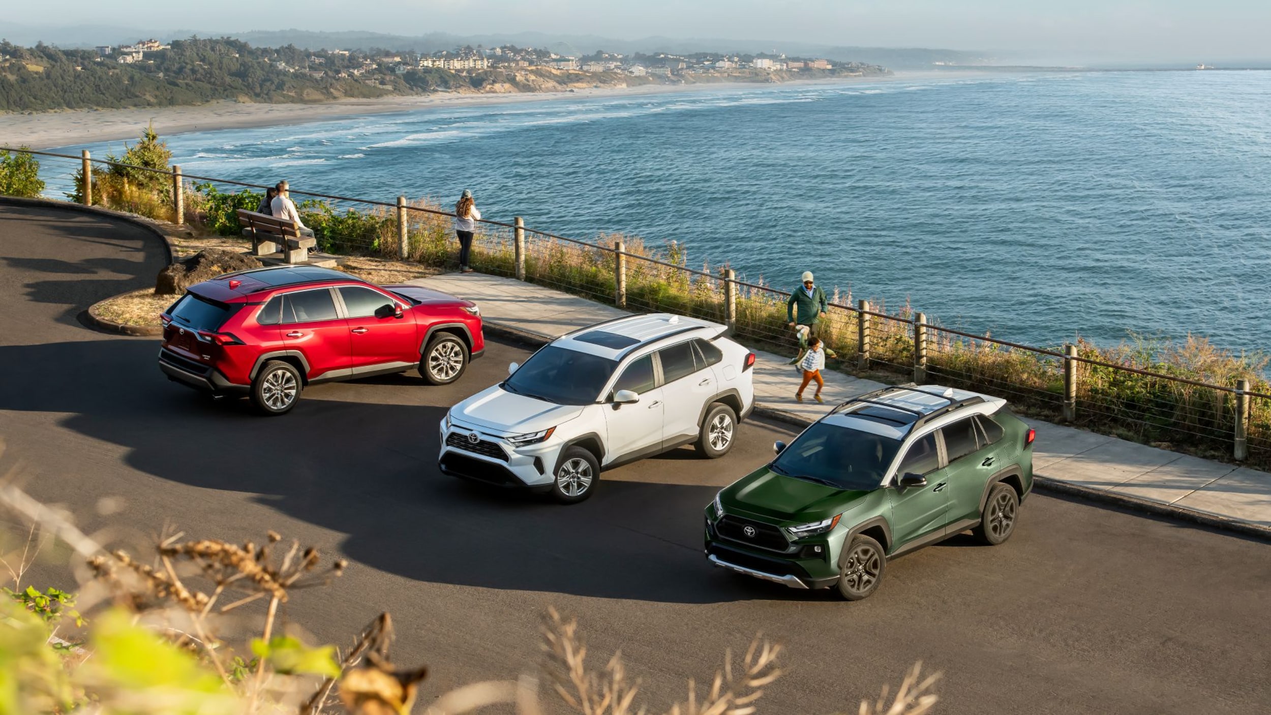 New 2024 Toyota RAV4 Near Bryan, TX shown in Ruby Flare Pearl, Ice Cap, and Army Green with Ice Edge roof.png