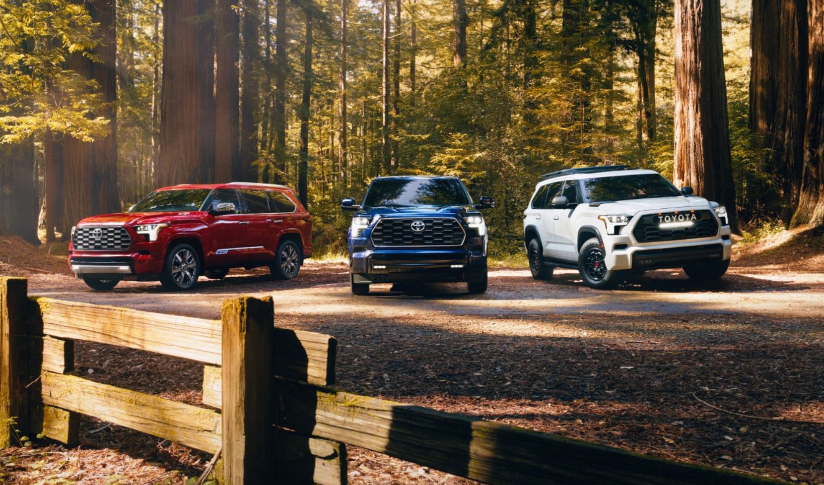 2024 Toyota Sequoia Capstone 4WD shown in Supersonic Red, * Platinum 4WD shown in Blueprint, and TRD Pro shown in Ice Cap near Madisonville.png