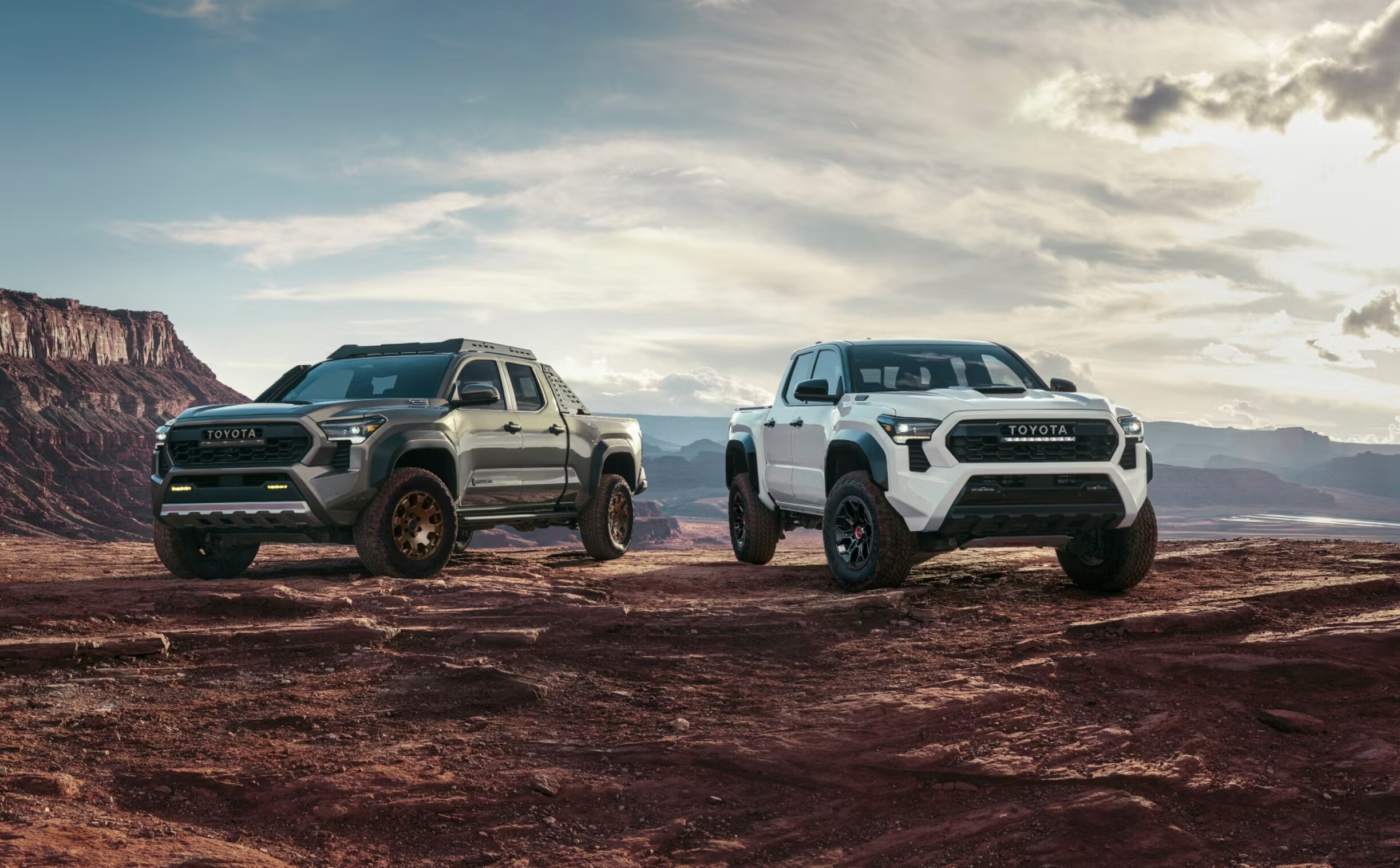 2024 Toyota Tacoma Trailhunter shown in Bronze Oxide; TRD Pro shown in Ice Cap with Black roof in Huntsville, TX