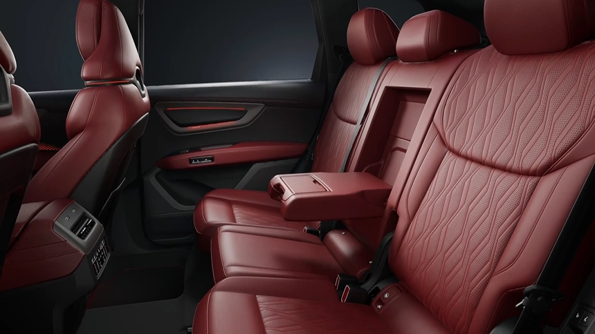 Red leather second-row seats with a folding center armrest inside the Audi Q7