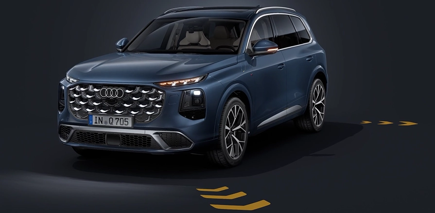 Blue Audi Q7 in a dark studio projecting yellow directional turn-signal arrows onto the floor