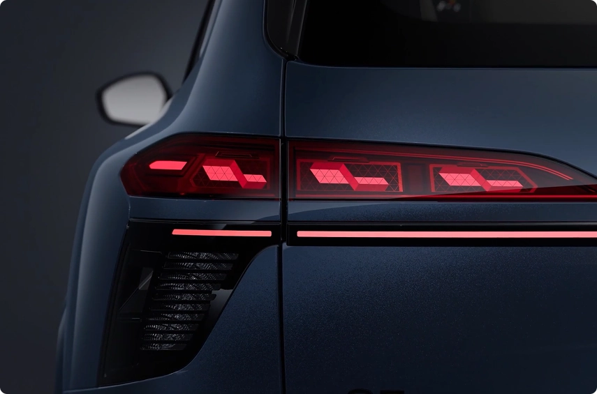 Close-up of the illuminated segmented OLED taillight on a dark blue Audi Q7