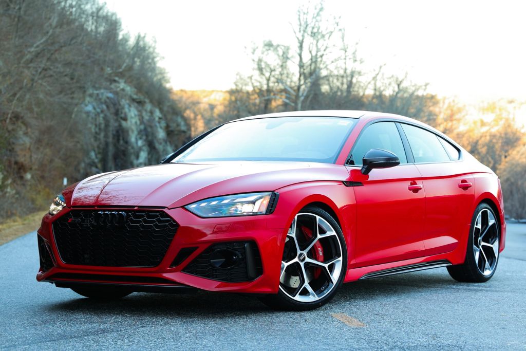 audi-rs5-asheville-nc.jpg 2024 Audi RS5 Sportback, shown in red, parked in the road amongst a wooded setting in Asheville, NC