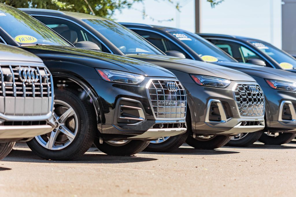 executive-demo-audi-cars-asheville-nc.jpg Row of premium used Audi cars and SUVs for sale, executive demo vehicles, lined up in front of Audi dealership in Asheville, NC