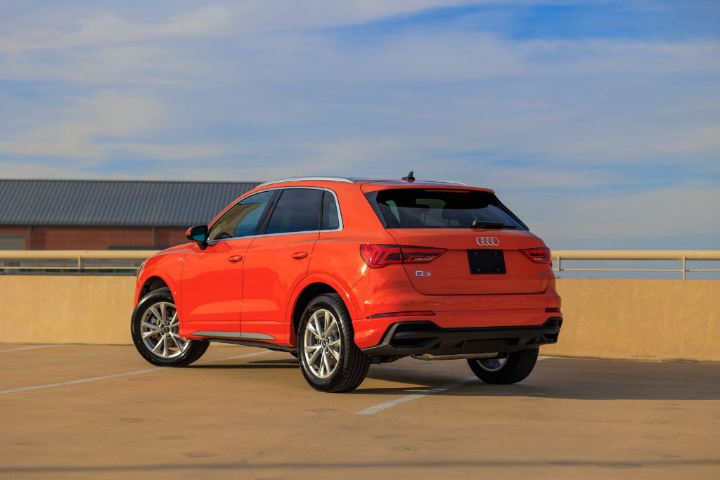 audi-q3-for-sale.jpg Rear view of 2024 Audi Q5 for sale in North Carolina, shown in orange with blue sky in background