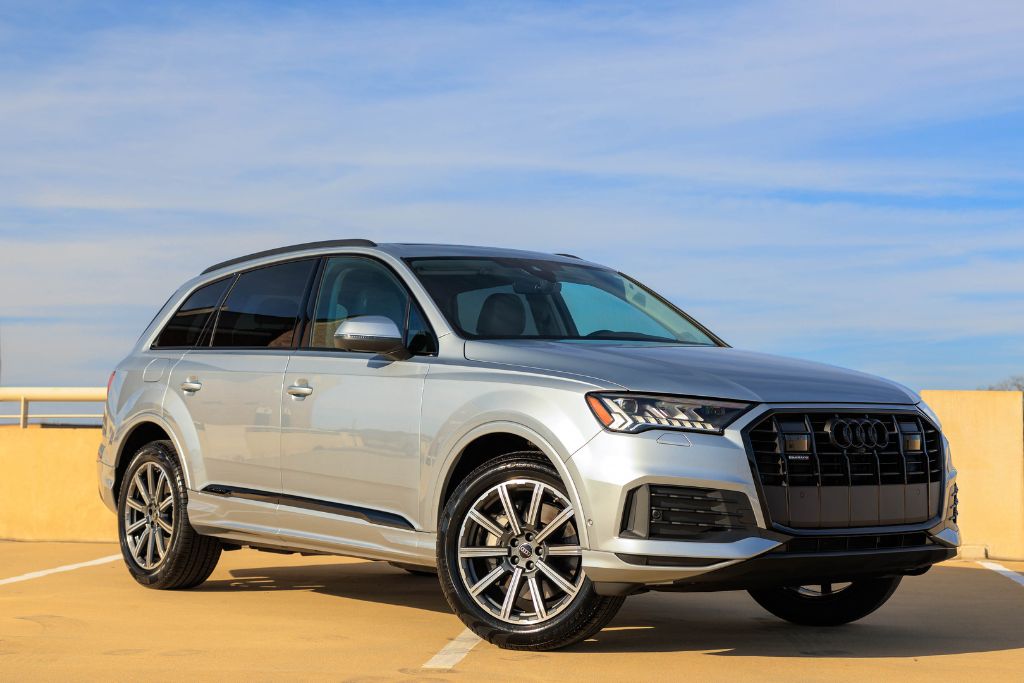 audi-q7-asheville-dealership.jpg Audi Q7 for sale, shown in silver color, front side view of parked SUV with blue sky in background