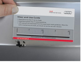 Audi Wear and Use Guide being used to measure scratch