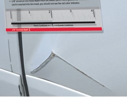 Audi Wear and Use Guide being used to measure a large scratch