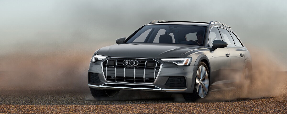 Audi allroad driving through a gravel road