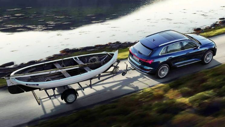 blue_2023_audi_etron_sportback_pulling_trailer_with_boat_