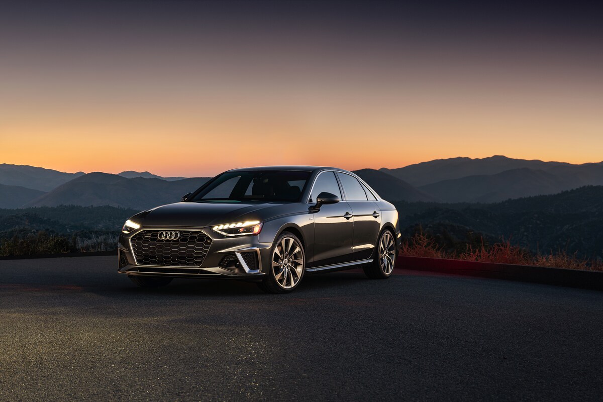 2022-Audi-A4-PremiumPlus-45TFSI-WheelAddOn-Sedan-L13.png dark gray Audi A4 sedan parked overlooking desert mountains