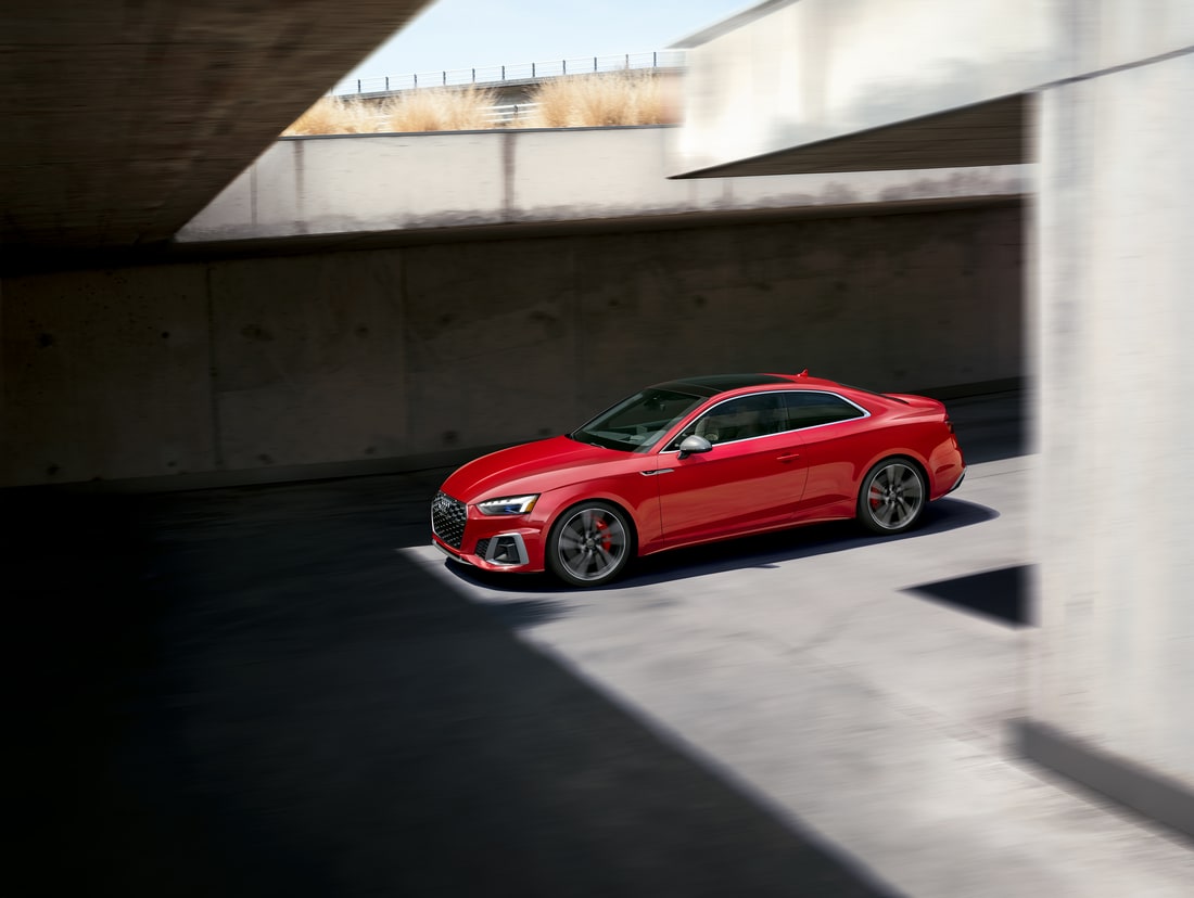 2021-Audi-S5-Prestige-SSSportPackage-Sportback-L01.png red Audi S5 parked in an empty cement lot