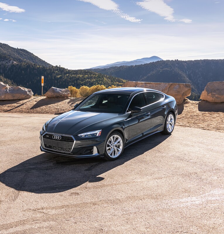 2022-Audi-A5-PremiumPlus-40TFSI-Sportback.png dark gray Audi A5 sedan parked on a sandy outcropping