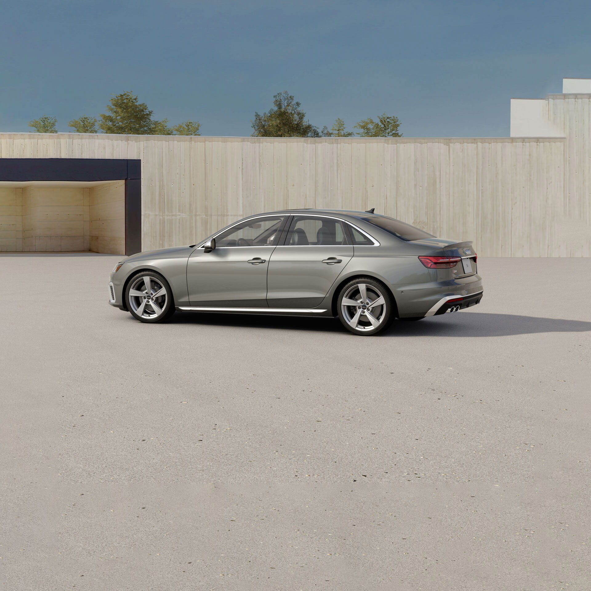 silver Audi S4 sports sedan parked on a sand lot
