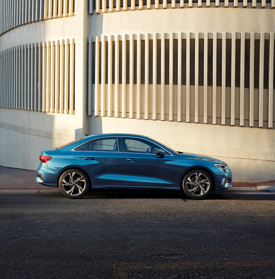 2023-Audi-A3-40TFSI-Prestige-WheelAddOn-Sedan.png teal Audi A3 sedan parked in front of a cement structure