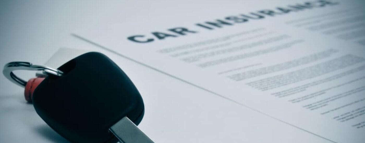 Car key on insurance paperwork