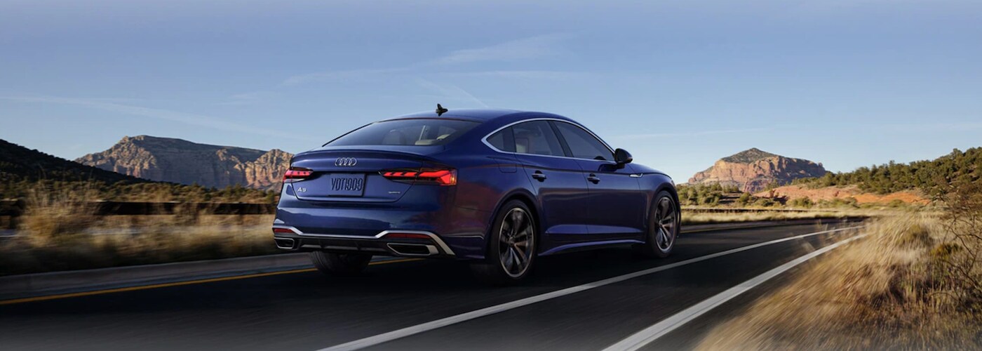 Blue 2021 Audi A5 driving on desert highway