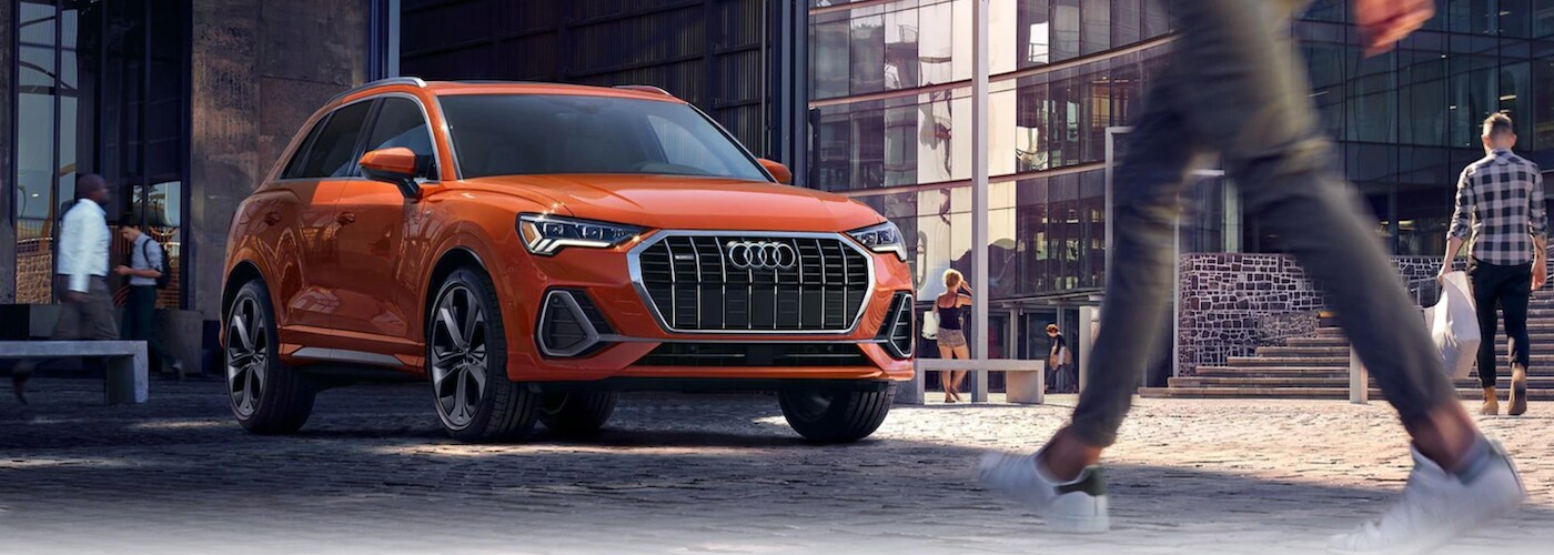 Orange 2021 Audi Q3 parked near pedestrians