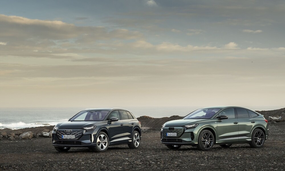 Two Audi Q4 SUVs parked on a rocky beach