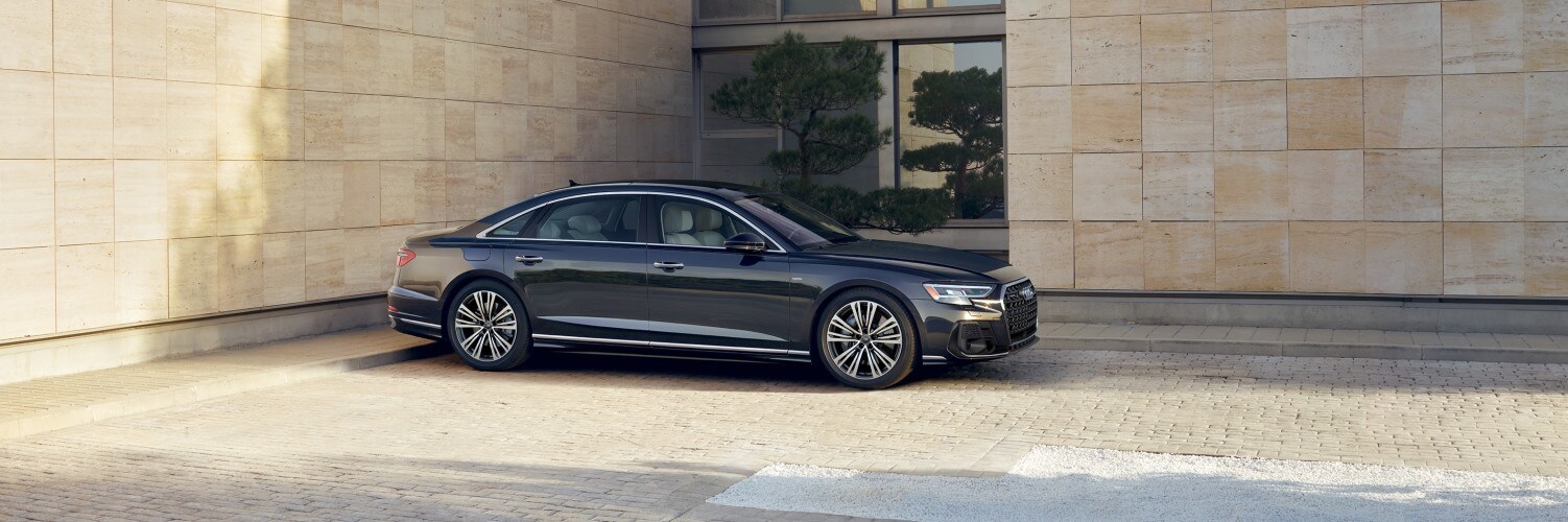 Audi A8 Blue Audi A8 Premium parked near city skyline