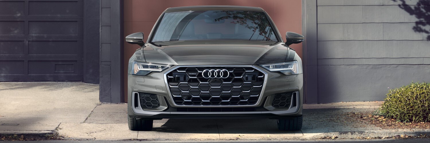 Audi A6 Gray Audi A6 parked in front of a modern home