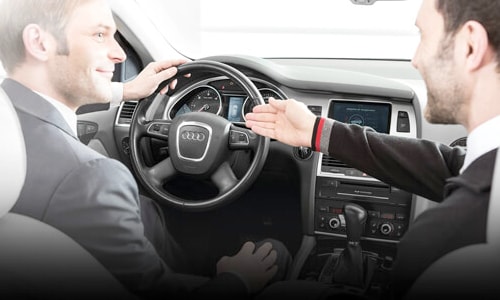 2 Men sitting inside an Audi