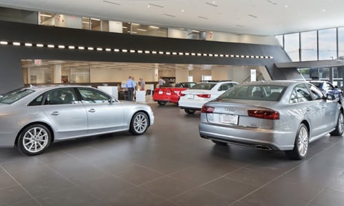 Interior shot of an Audi dealership with people shopping