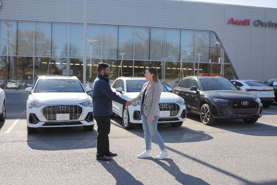 Audi Owing Mills staff Audi Owing Mills staff greeting a customer near front of dealership