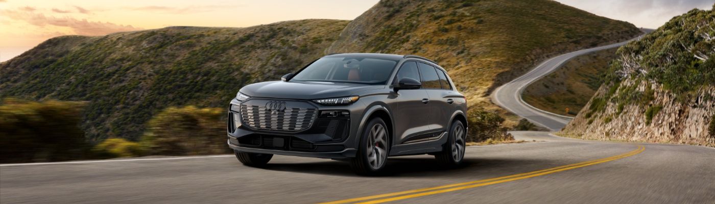 Audi SQ6 e-tron Audi SQ6 e-tron driving on a curvy mountain road