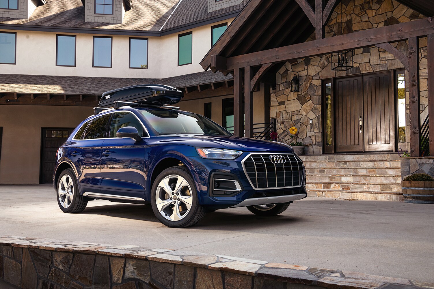 Model Features of the 2021 Audi Q5 at Audi Owings Mills | 2021 Audi Q5 parked outside of house