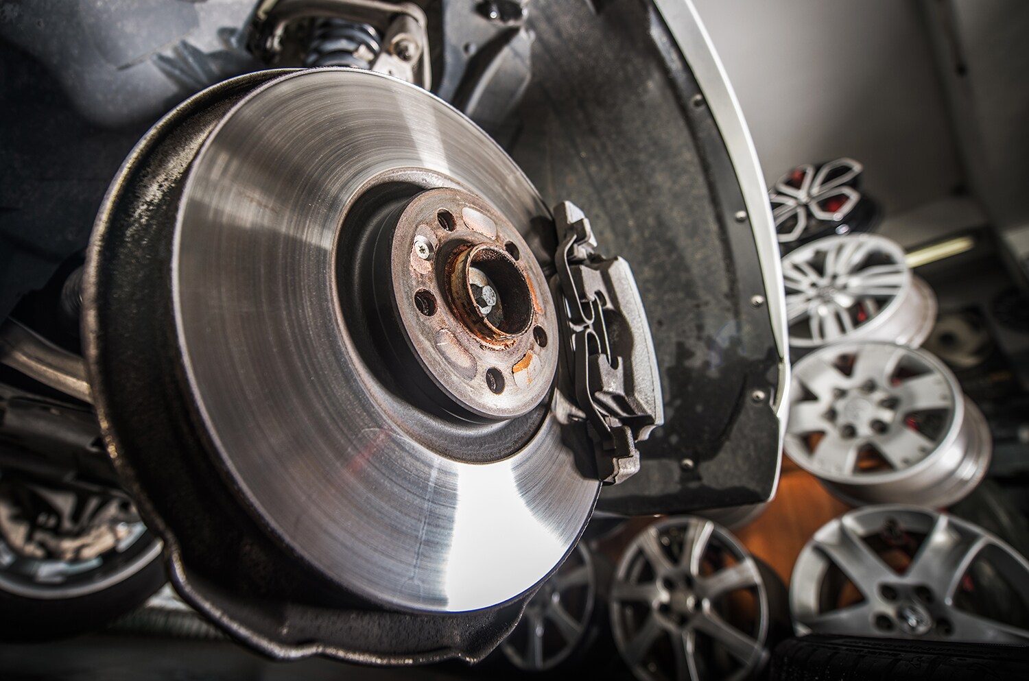 Audi Owings Mills is a Car Dealership in Pikesville near Owings Mills MD | Mechanic fixing brakes