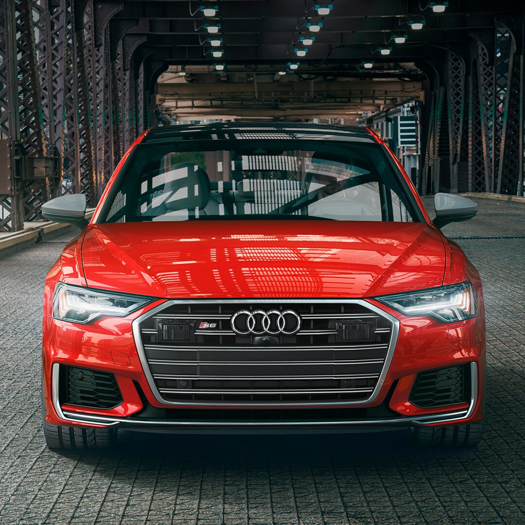 Audi Owings Mills is a Car Dealership in Reisterstown near Owings Mills MD | Red MY20 Audi S6 driving on city bridge