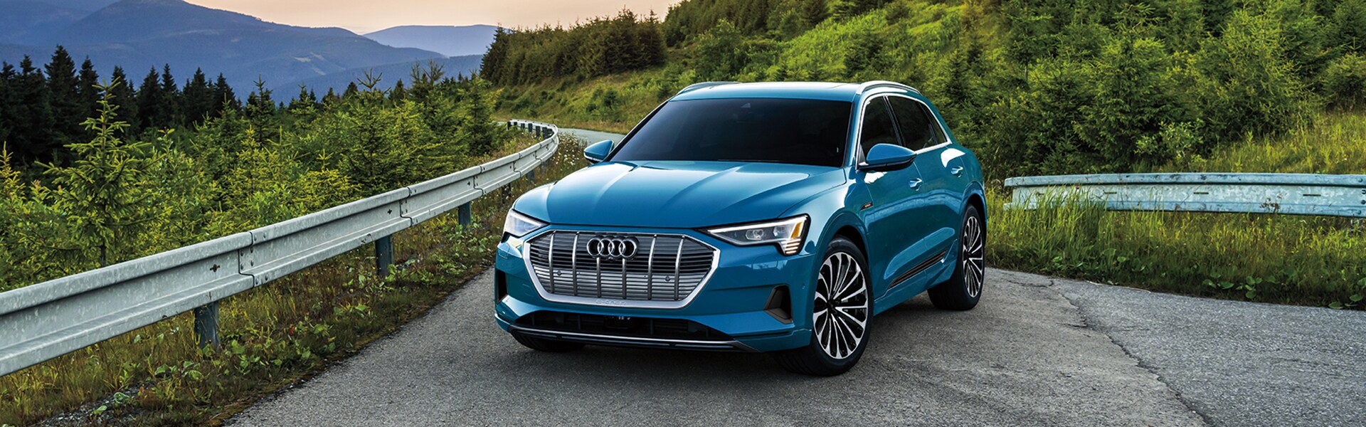 Benefits of Changing Your Audi’s Oil at Audi Owings Mills in Owings Mills | Blue e-Tron Parked In Front of Mountains at Sunset